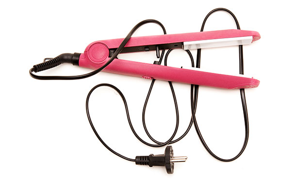Image of a set of hot pink hair straighteners with the wire.