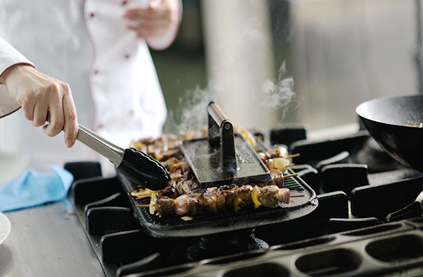 Lamb skewers being cooked by a Chef.