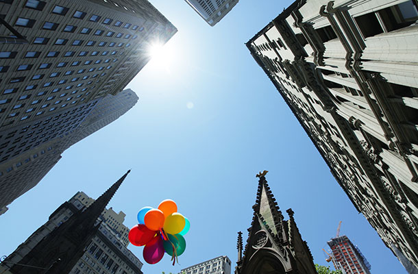 Image of Manhattan sky with balloons floating.