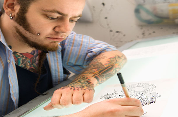 Image of tattoo artist drawing.