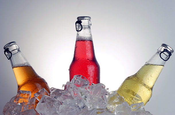 Bottled drinks in an ice bucket.