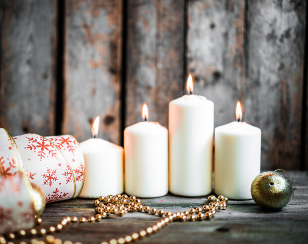 Christmas decorations with candles on wooden background