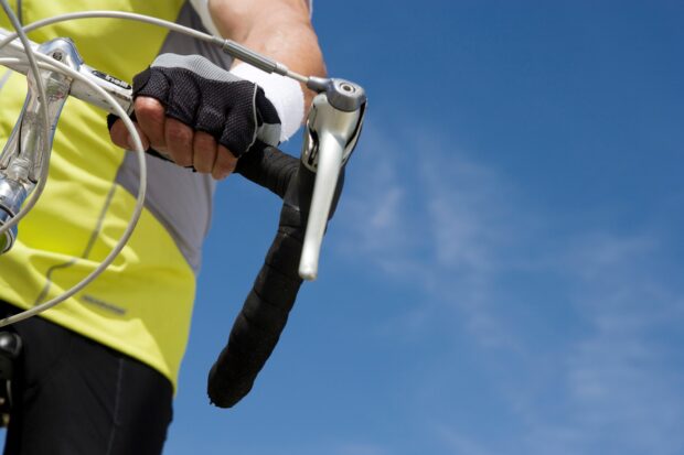 handle bars and cyclist hands with glove.