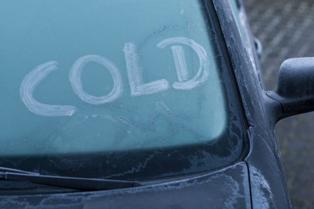 Frost on car with the word cold written on the windscreen