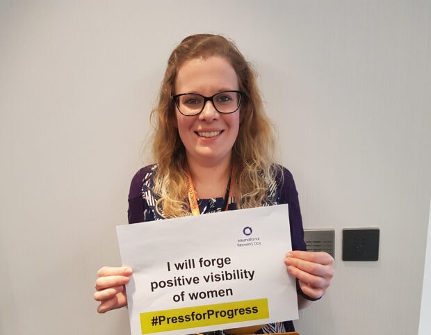 Georgina Menzies holding a pledge sign