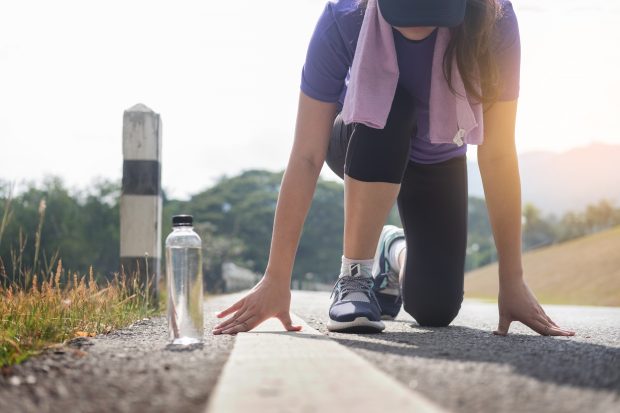 young woman at starting position ready to start a race. 