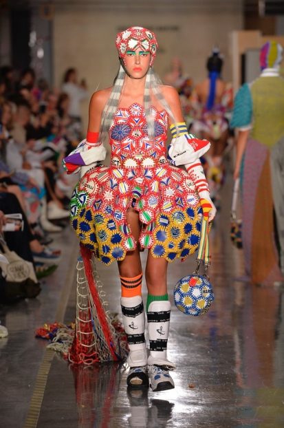 Model on catwalk wearing vibrant outfit designed by Paolina Russo