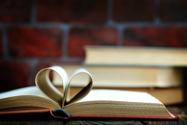 A book with pages folded to make a heart