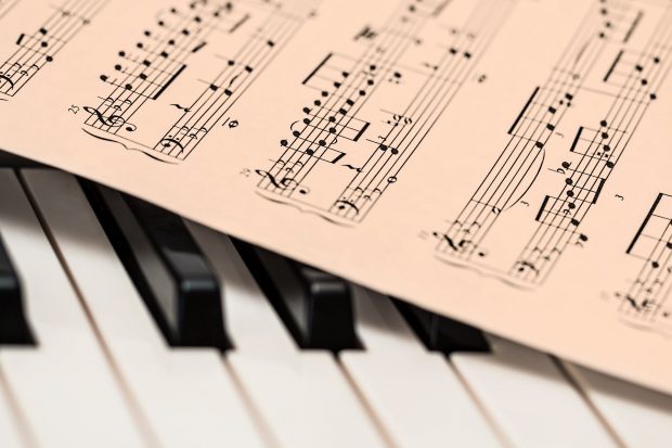 music sheet across piano keys