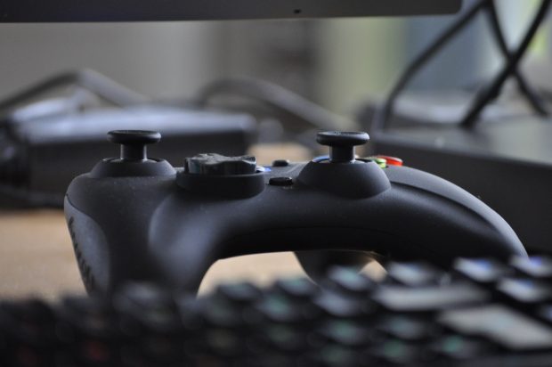 Games controller next to a computer keyboard