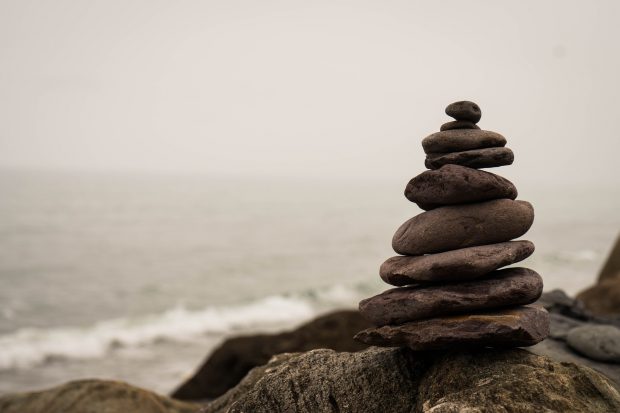 Stones piled on top of each other next to the sea.