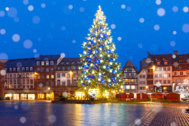 Christmas tree decorated and illuminated on the Place Kleber in Old Town of Strasbourg at night, Alsace, France