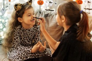 Young girl in pussy cat costume gets ready for Halloween. Avoiding counterfeit costumes. This image illustrates our article about counterfeit costumes. If the price seems too good to be true, it probably is. 
