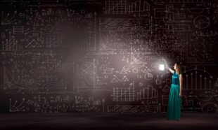 Woman shining light on scientific calculations