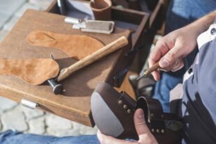 Hands making shoes