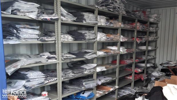Shelving unit in warehouse filled with counterfeit football shirts