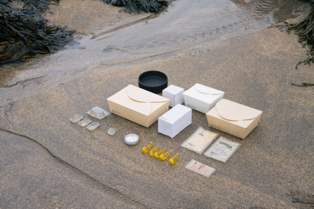A variety of Notpla's packaging on the beach.