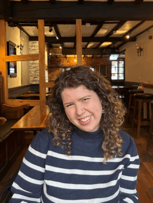 An image of Meg as an adult with more defined curls