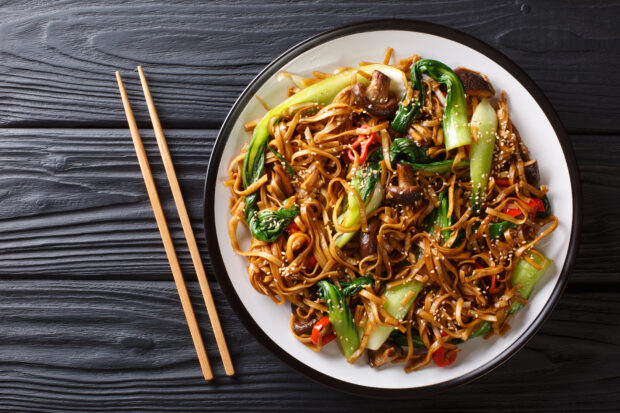 A bowl of pad thai with chopsticks