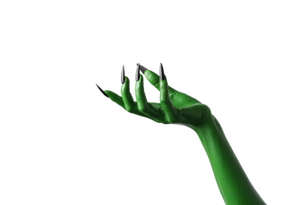 Green witch's hand on white background.