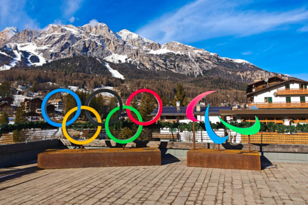 An image of the Olympic Rings and Paralympic Agitos in front of the dolomites at the Milano Cortina Winter games